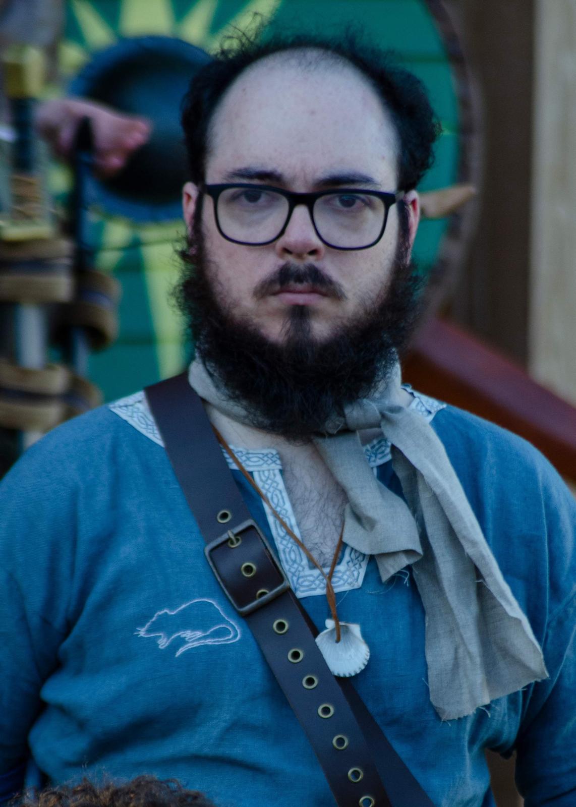Harald, without his battle kit, wearing a blue tunic, staring menacingly ahead